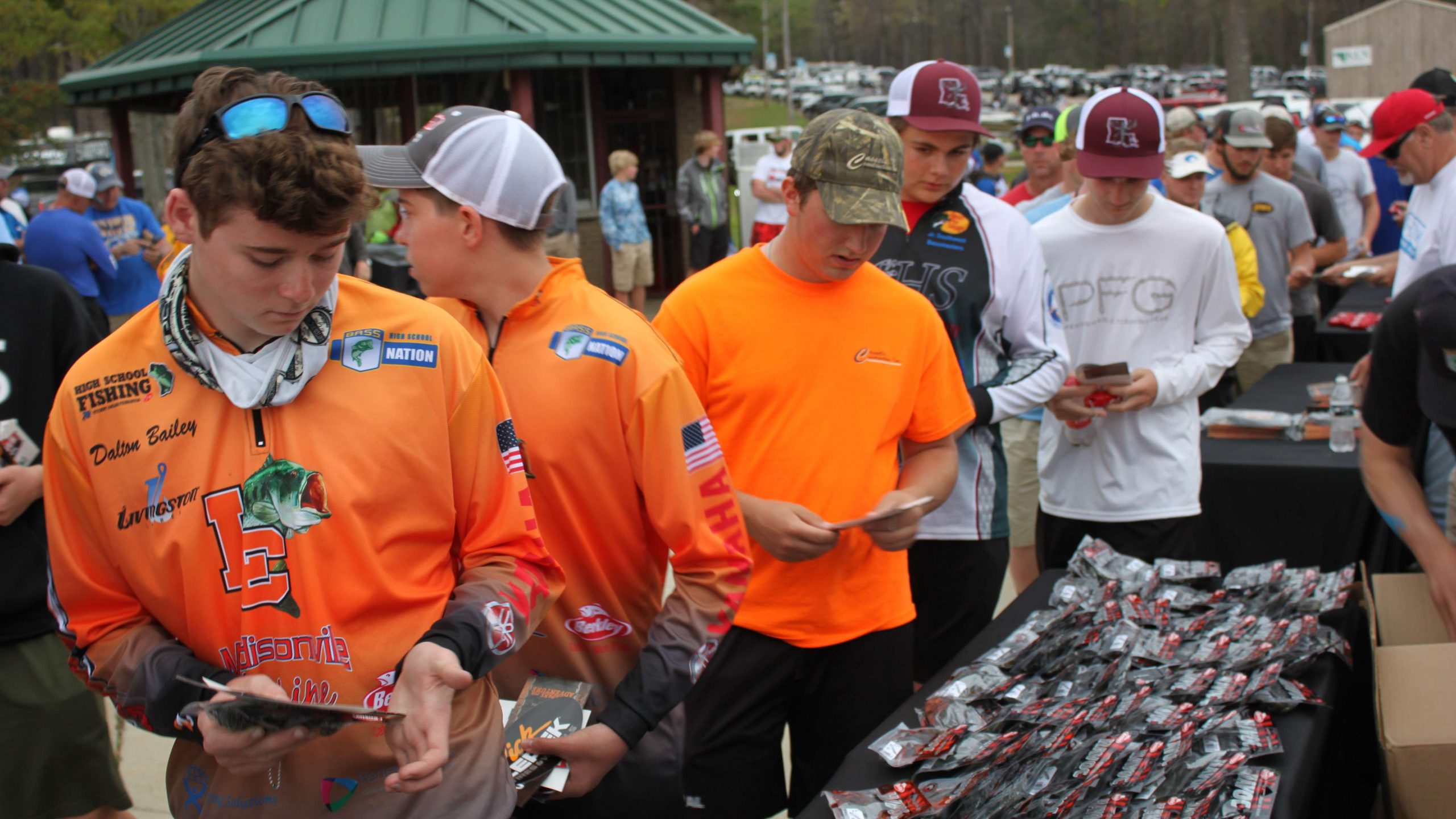 Anglers pick up some Berkley Havoc lures in the foreground.
Check out the mob of cars and boats in the parking lot in the
background. With 180 teams competing in this tournament, Cypress Bend
Marina is sure to be busy when the anglers launch Saturday morning at 6:15 a.m.