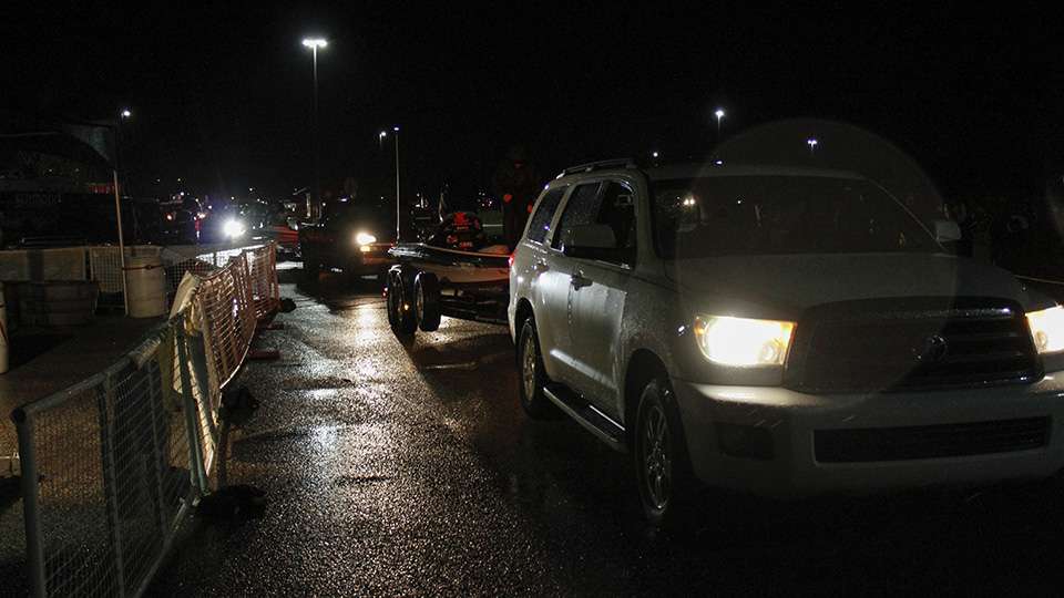 The line of trucks and boats began to funnel through the dark towards the ramp.
