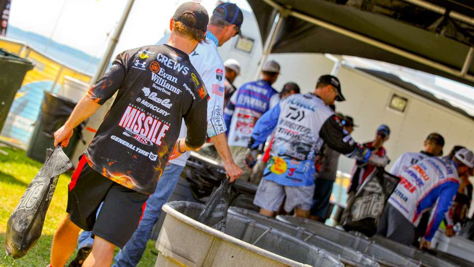 The anxiousness begins here. The line forming at the weigh-in tanks. Those are backstage. âYou start getting nervous, feeling butterflies in your stomach. You are getting in line with the best of the best, right there.â Ahead of Crews are bags of bassâand no one yet knows their exact weightsâcaught by the best bass anglers in the world. 
