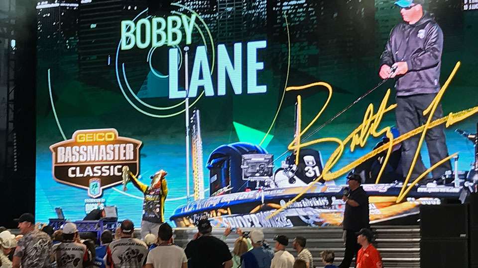 Bobby Lane holds his fish under a rather impressive graphic of him on the water, his name up in lights along with his signature. He had a decent first day, finishing 18th with 16-0. He ended up eighth.