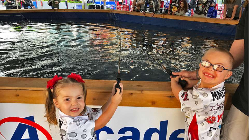 Just outside the expo was the Shell Bassmaster Get Hooked on Fishing presented by Academy Sports + Outdoors. Jaylee, 3, and Joseph Maughon, 5, of Killeen, Texas, mug for a moment as they try their hand at the fishing pond where catfish were being caught.