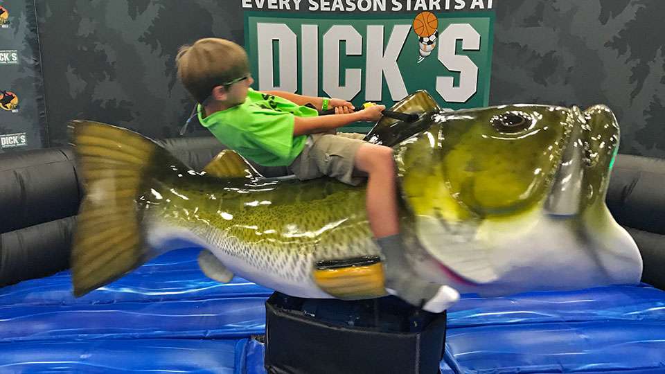 Another of the more popular expo attractions, for young and old, at the expo was the buckinâ bass at a DICKâS Sporting Goods booth. Tyler Charron, 10, of Inez, Texas, does his best to hold on to the spinning, gyrating fish, which had folks lined up to try. (Go to Facebook to watch Fred Roumbanis give it a whirl, literally.)