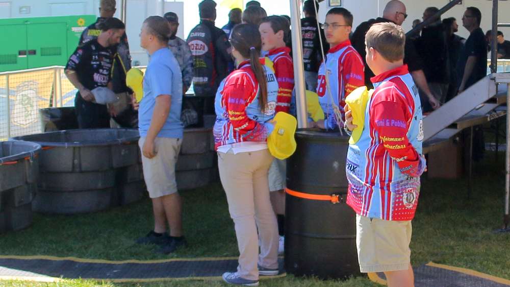 Local youth anglers partake in the National Anthem before helping with weigh-in.
