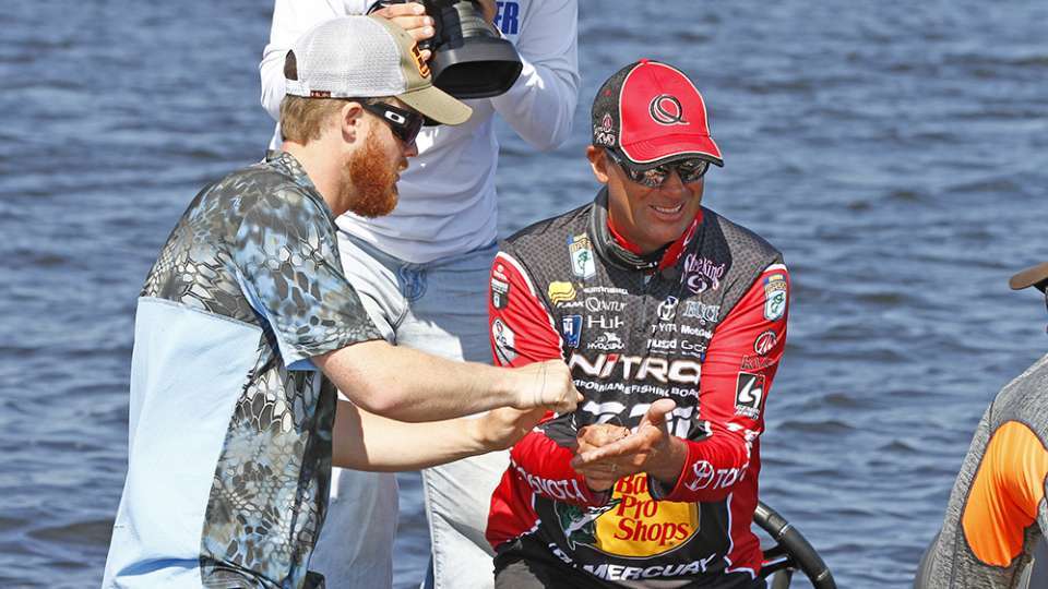 Aided by Bassmaster photographer Garrick Dixon, left, VanDam provided step-by-step instructions on how to use a length of braided fishing line to quickly and almost painlessly remove a barbed hook.