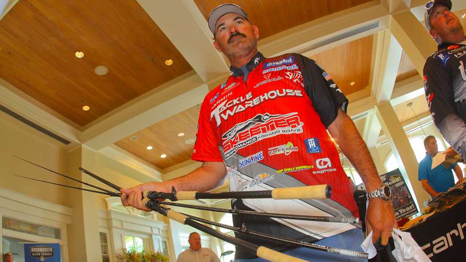 Jared Lintner is holding two nearly eight-feet long rods he will use on Toledo Bend. New rules this year from B.A.S.S. allow anglers use rods up to 10 feet long. Lintner said when he first used the long cranking rod, he broke his bait off on his Power-Poles on the backcast. 
