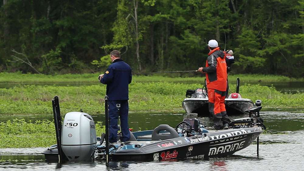 With Jesse Wiggins looking on, Chad Morgenthaler fights a bass back to the boat. 