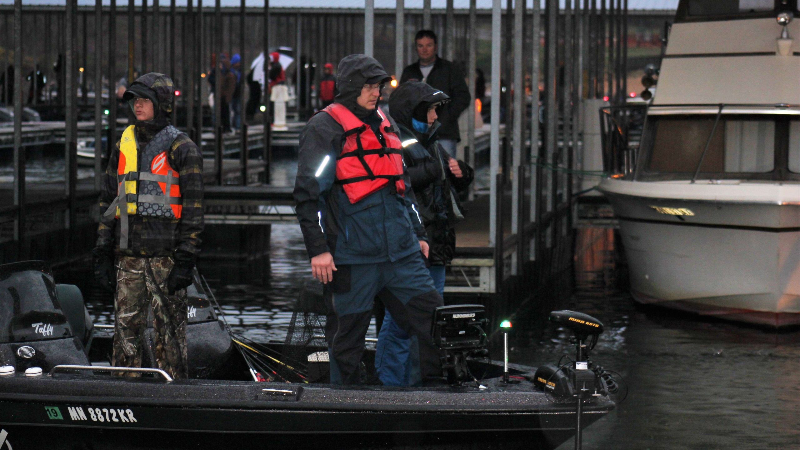 This team idles up to the dock as raindrops fall all around.