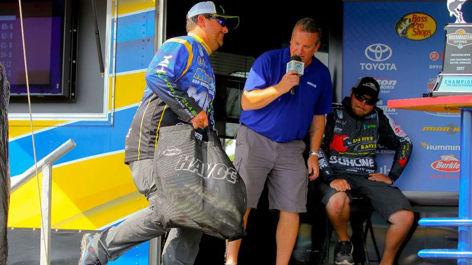 He lifts a sack full of Chickamauga bass onto the stage.