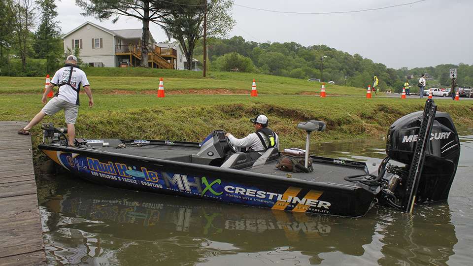 Florida pro John Cox rolls into weigh-in and parks his boat beside the shore.