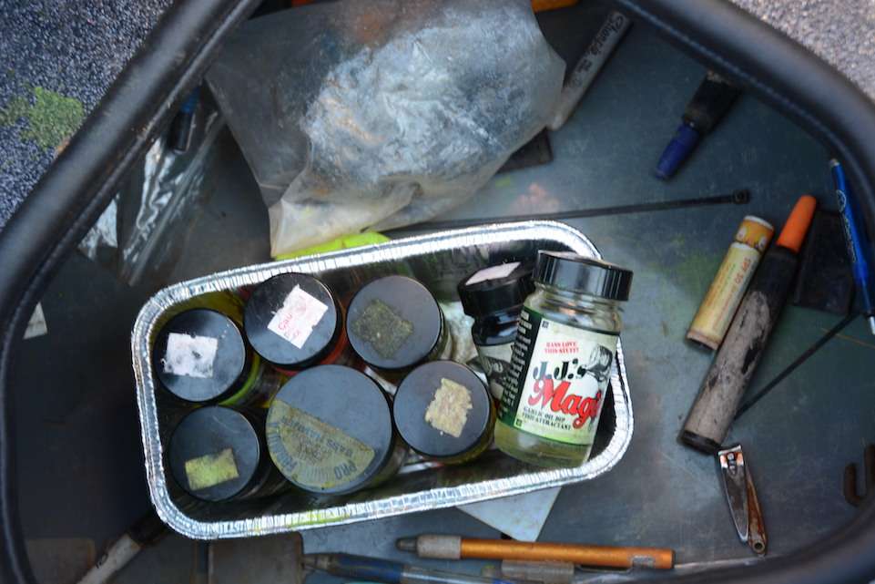 This below passenger-seat compartment provides quick access to odds and ends. Stored inside this pound cake baking pan are various colors of J.J.âs Magic Dippinâ Dye. Also inside the storage are pens for marking lures. 
