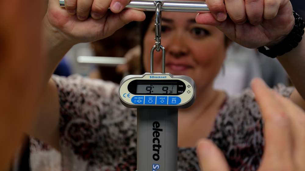 Kerri Bonner holds her scale up as the bag weighing 9-9 shows the correct weight. 