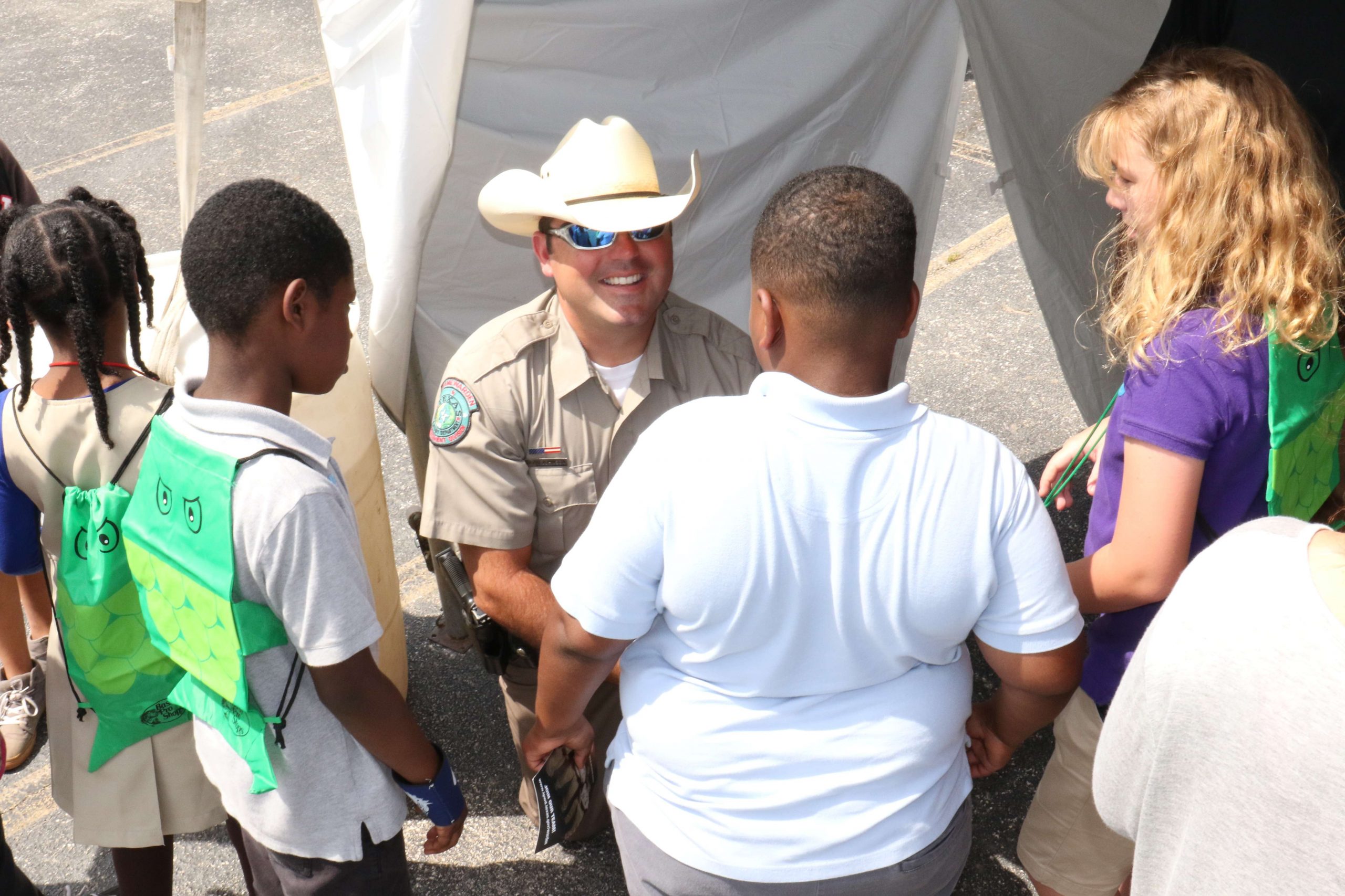 Others meet a game warden wearing a real cowboy hat. 