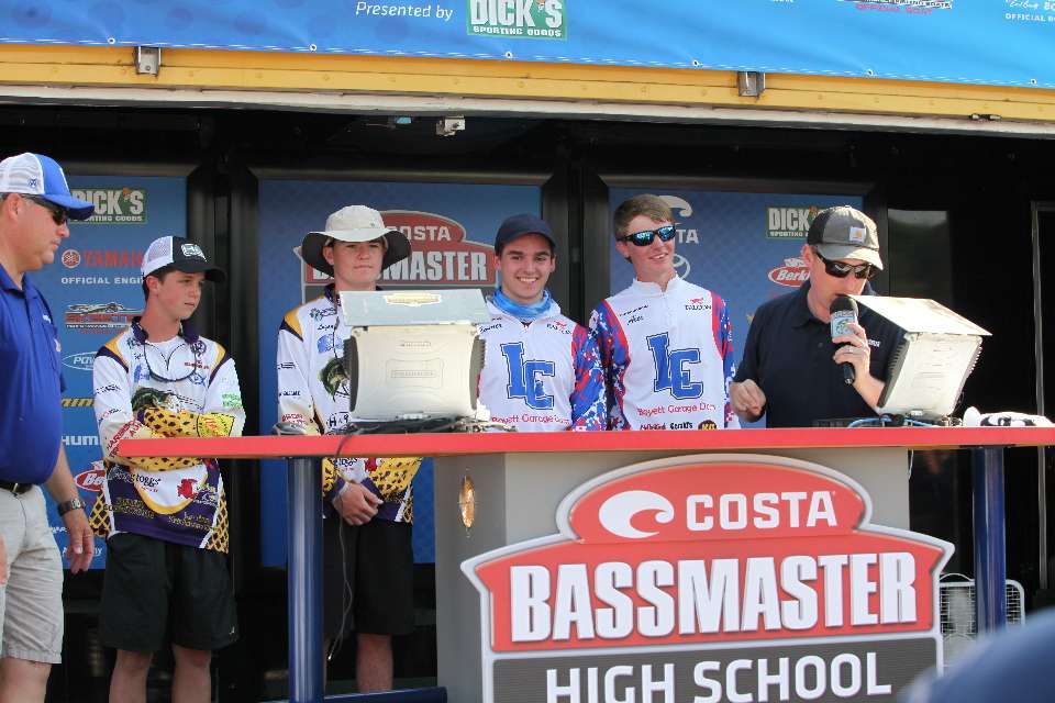 Alex Gault and Connor Phillips wait with the Springville team to see who will win the tournament. 