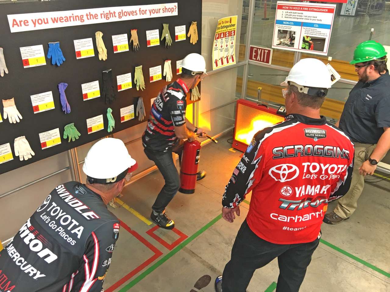 Each of the three pros tried their hand at proper fire extinguisher use in the safety training area.
