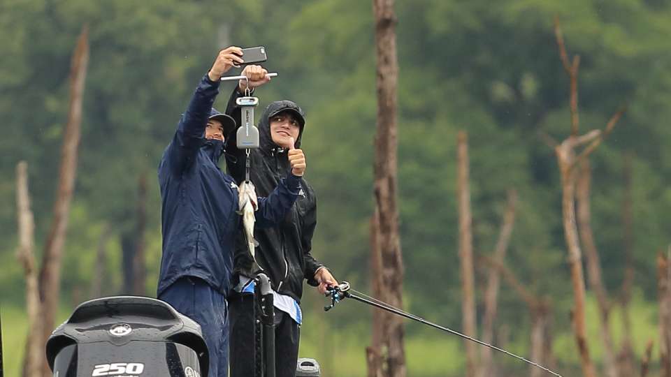 They weigh the bass and document with a selfie.