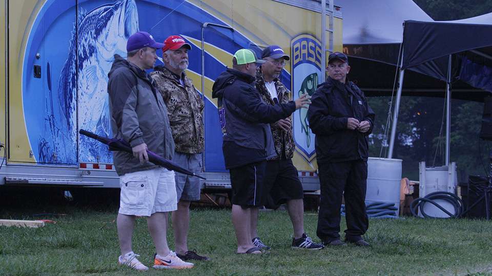 All of the fishing team coaches gather around and tell stories.