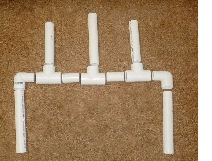 1. Cut a length of 1 1/4-inch PVC tube for holders and support posts. We made the middle tube longer to separate the reels in the final product. Small sections of the same tube fit between Ts and establish width. 