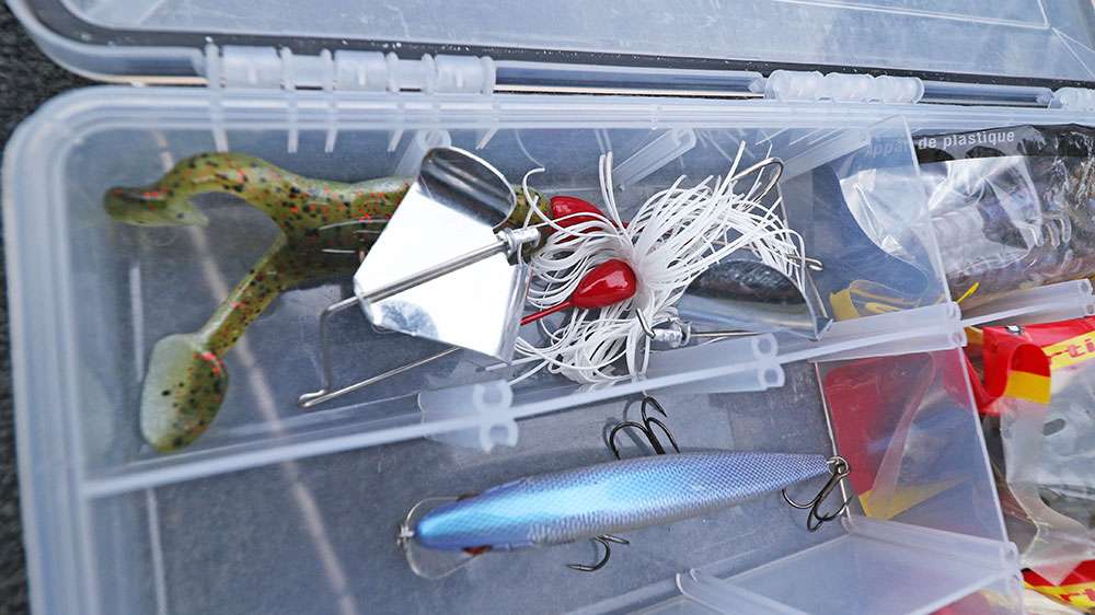 See that froggy looking thing at the bottom? That's a soft plastic frog-like trailer he likes to put on his buzzbaits. It slows the sinking process, which allows him to get the egg-beater-like prop spinning sooner, thus keeping the lure in the strike zone longer. And that means more fish. 