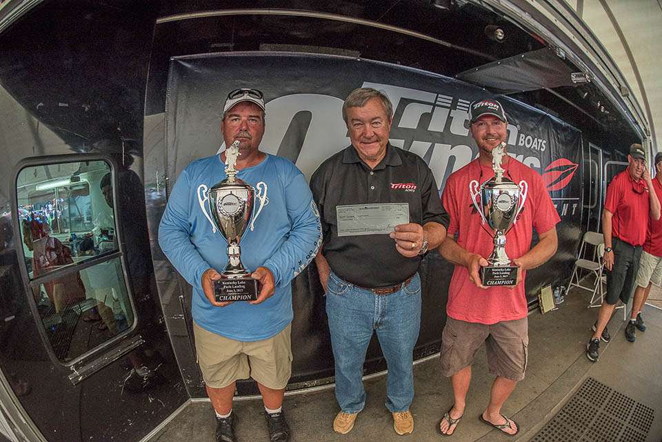 Mr. Earl Bentz presenting Gary and Jonathon with their trophies and a check for $10,000.
