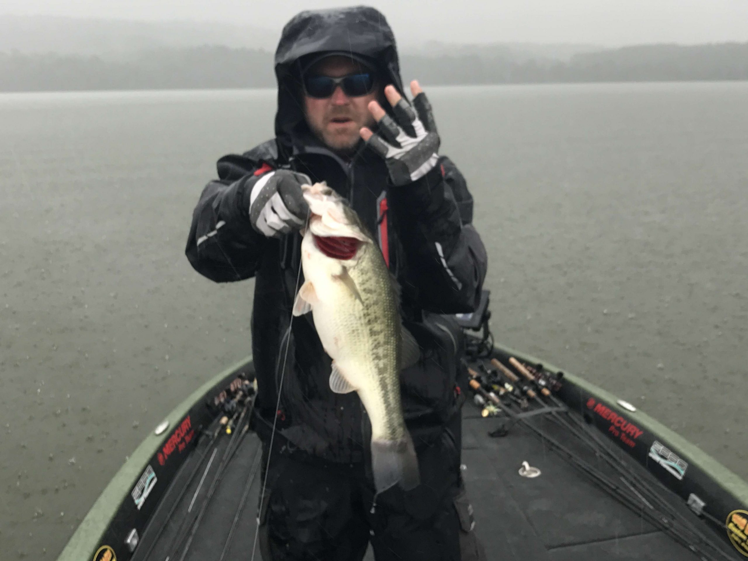 In a downpour, Mike McClellan boats a hard earned four pounder.