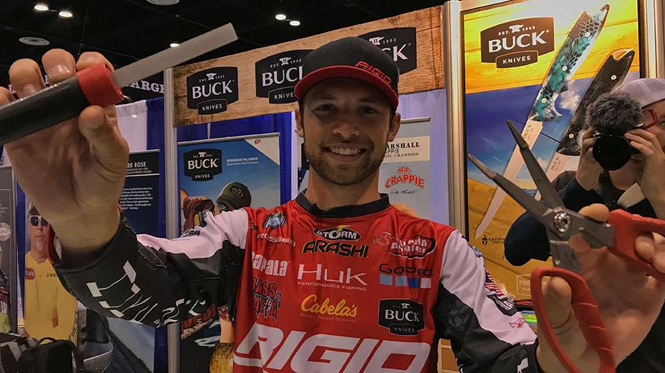 Brandon Palaniuk shows off what he called two critical tools, his Buck Knives EdgeTek Fishing FlipStik hook sharpener and its multi-function Splizzors.