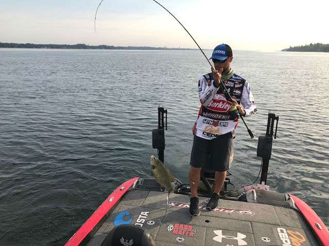 Justin Lucas flips his first fish into the boat.