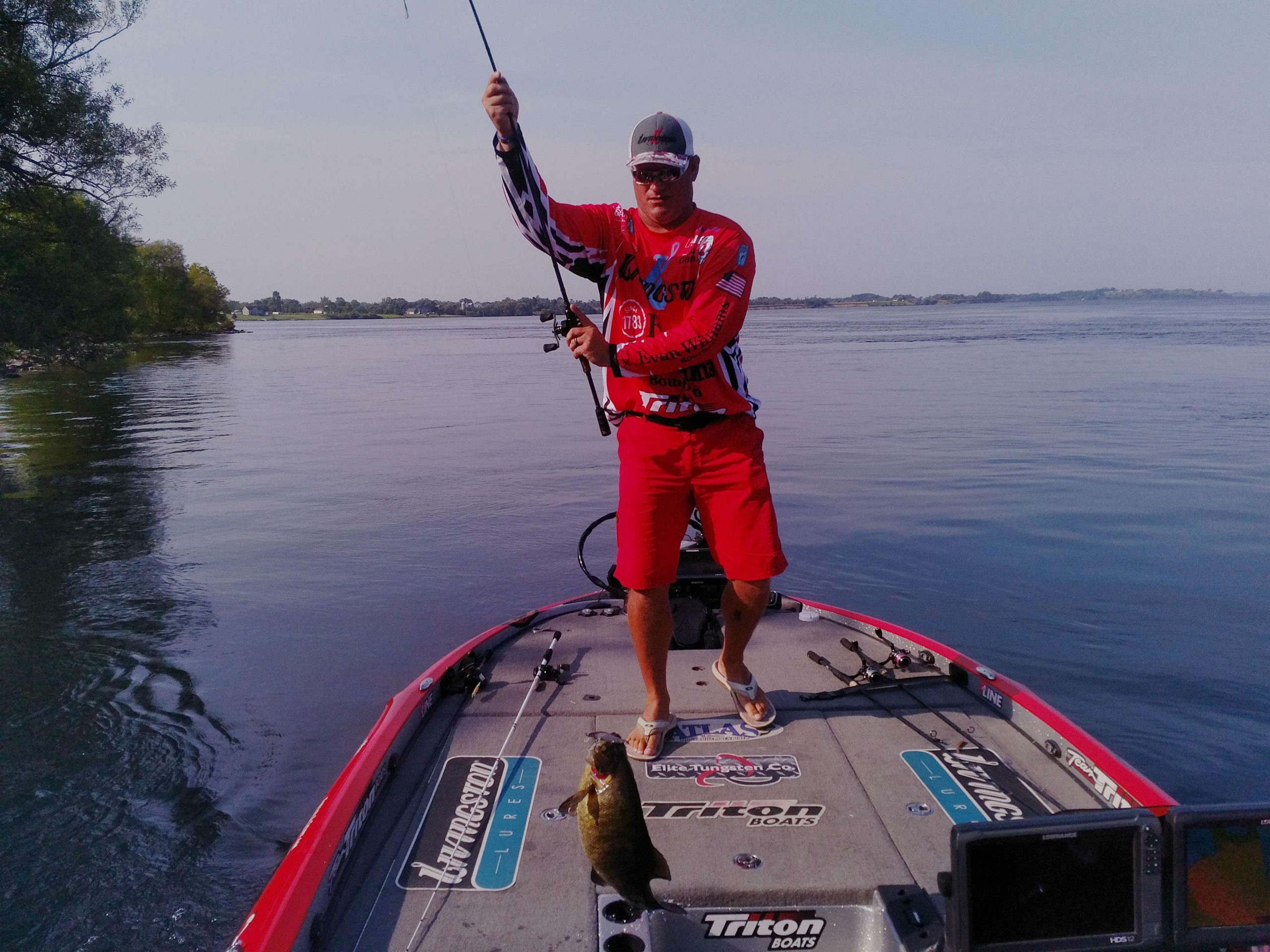 Hank Cherry boat flipping a 4+ on a jerkbait. He has 3 fish for about 12 pounds.