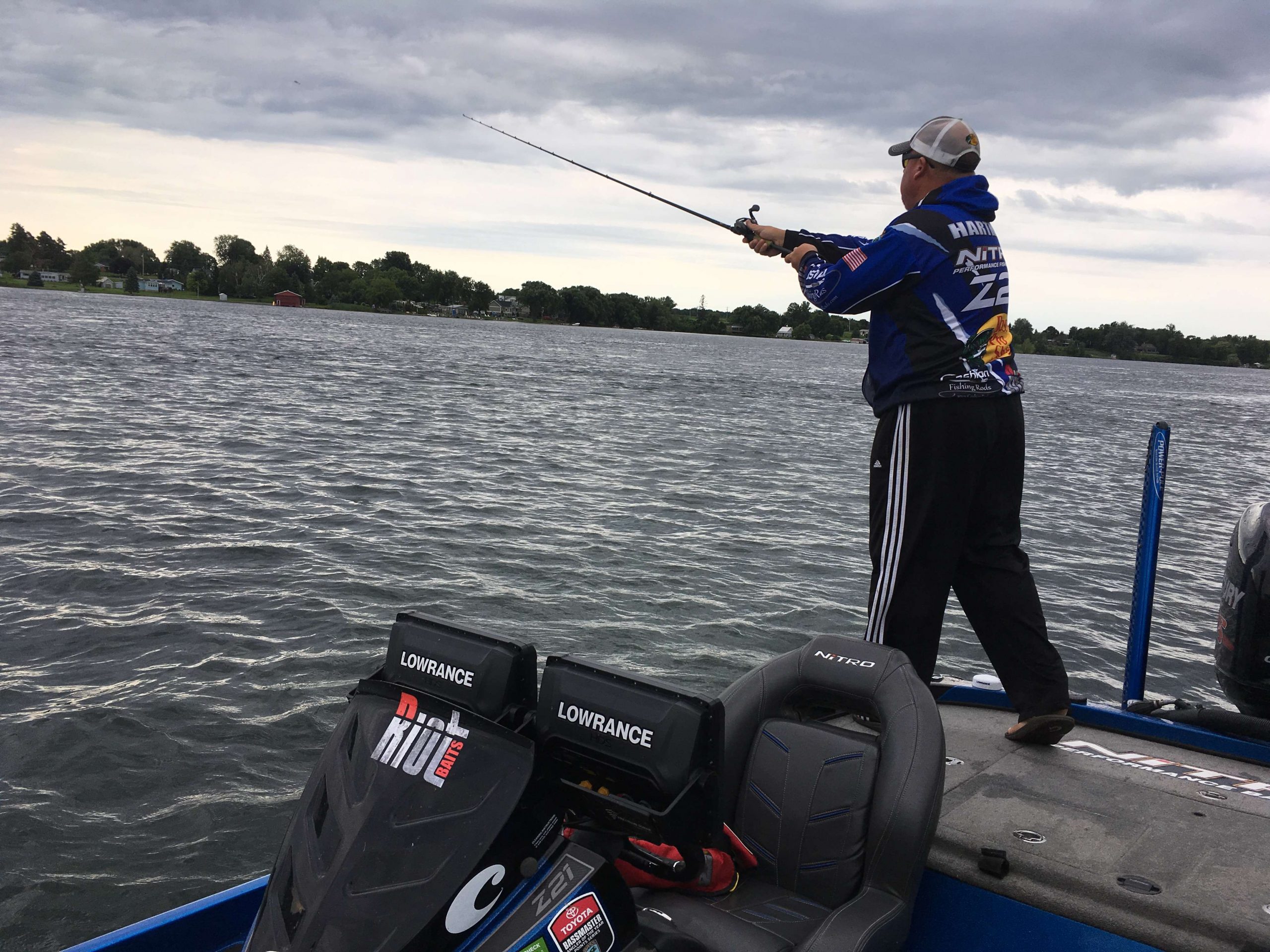 Jamie Hartman throwing out his baitcasting rod on the back deck of his boat. He's already in upgrade status & now he's in search of the giants.
