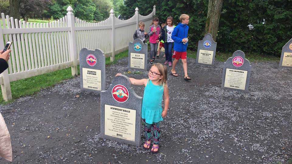 Estella Iaconelli poses at a tombstone in Ben and Jerryâs âFlavor Graveyard,â where the company pays respects to âdearly de-pintedâ flavors.