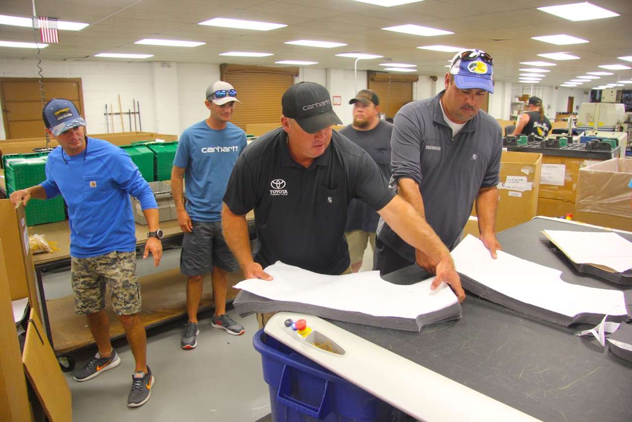 Scroggins and Zona work on boxing up recently cut patterns, as the Lee Brothers look on.