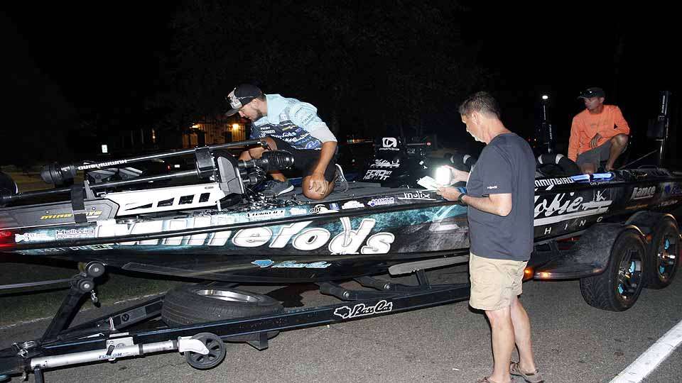 Eleventh place angler Carl Jocumsen prepares to be photographed with his best lures of the week for a Bassmaster.com photo gallery. 
