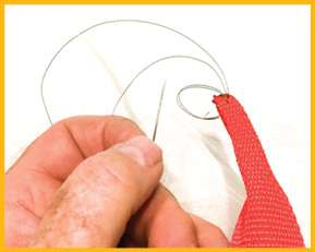 Fold the end of the strap lengthwise twice and, with at least 30-pound-test superbraid, sew it together to fit Â­inside the tube. 
