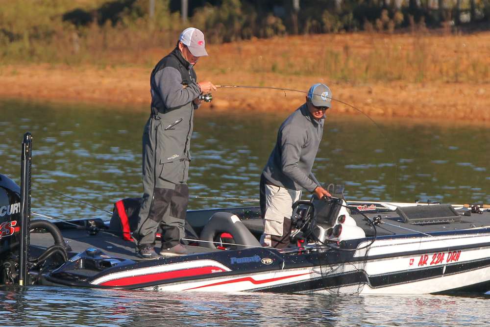 Matt Pangrac helps his co-angler, Brandon Rickman, bring a bass into the boat on Day 2. 