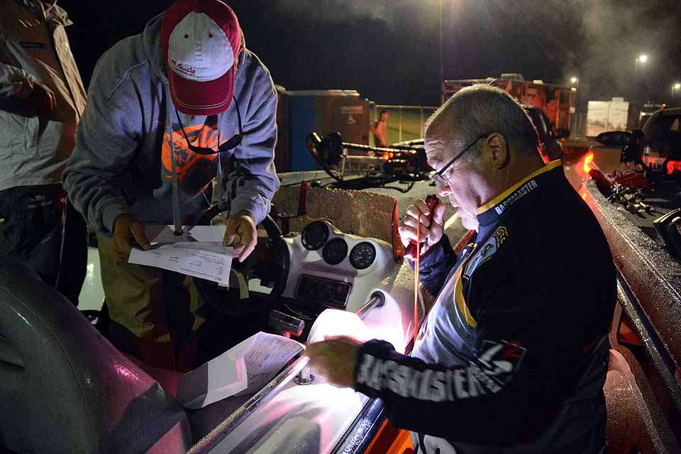 Alan Pearce of the B.A.S.S. staff checks insurance papers for an angler prior to the takeoff. 
