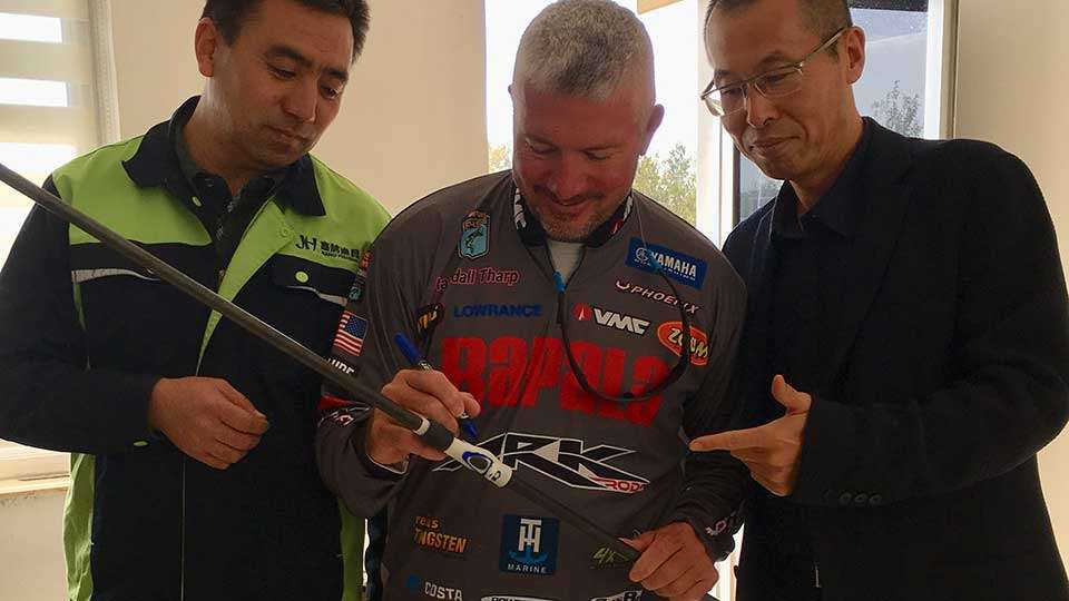 Tharp poses for some photos with two factory owners. There will be 14 different models in the Tharp signature line.