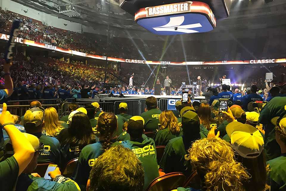 With lights flashing and fans in the GEICO stageside seats illuminated in yellow, Jordan Lee acknowledged the crowd as he walks on stage toward Mercer, Weldon,  the weigh-in scales and the Classic trophy.