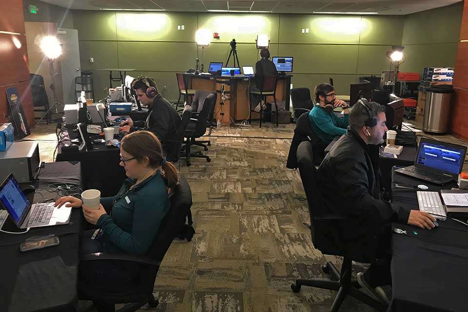 The War Room was brought back for 2018, and itâs where a lot of work was conducted on the live shows as well as weigh-in shows. At front left is B.A.S.S. Social Media editor Sara Frye-Sobolewski. In the back row, cameraman Ben Oliver works on editing video while graphics editor Bruce Cash works on designs that will adorn the video screens in the arena. IT manager Julius Morgan (front right) works to make sure everything electronic keeps working and help put out any fires.