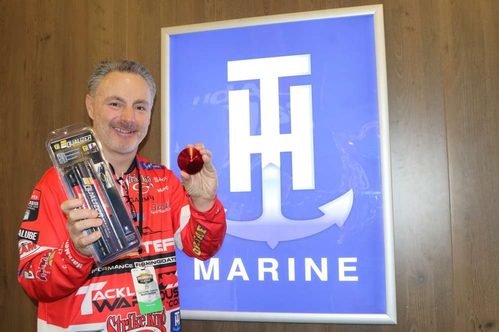 At the TH Marine booth, Elite pro Mark Menendez shows two of his favorite products: the Trolling Motor Lift Assist and the G-Force âThe Eliminatorâ Prop Nut.