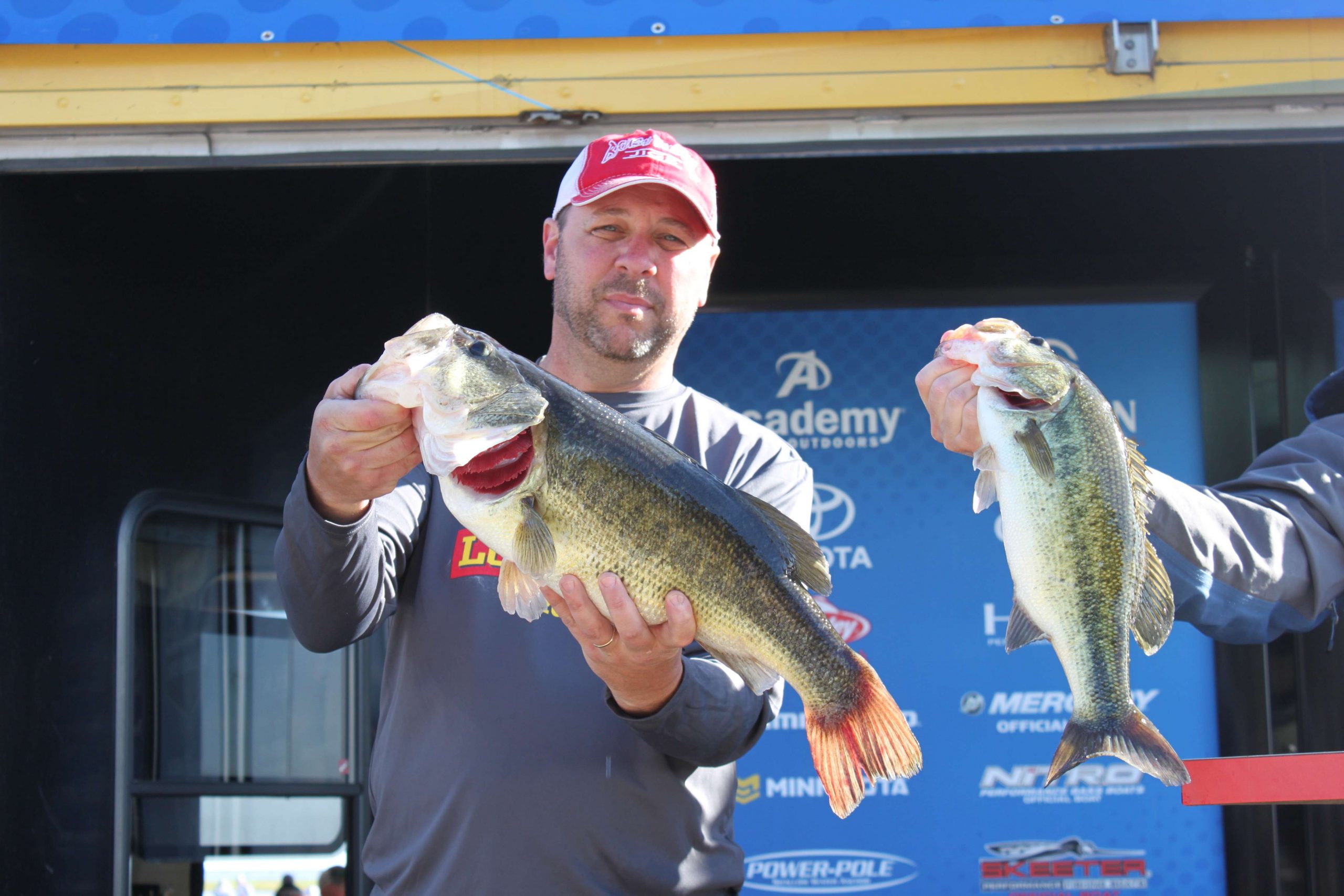Todd Newchurch, a non-boater for Team Louisiana, is third in the division with 21-15 over two days. That's a 7-pounder he's holding, while Hank Weldon inserts another big bass into the frame.
