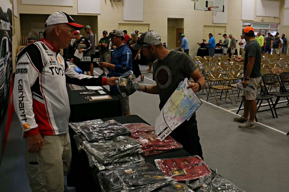 As anglers file in to register, they have some shirts and other swag to acquire.