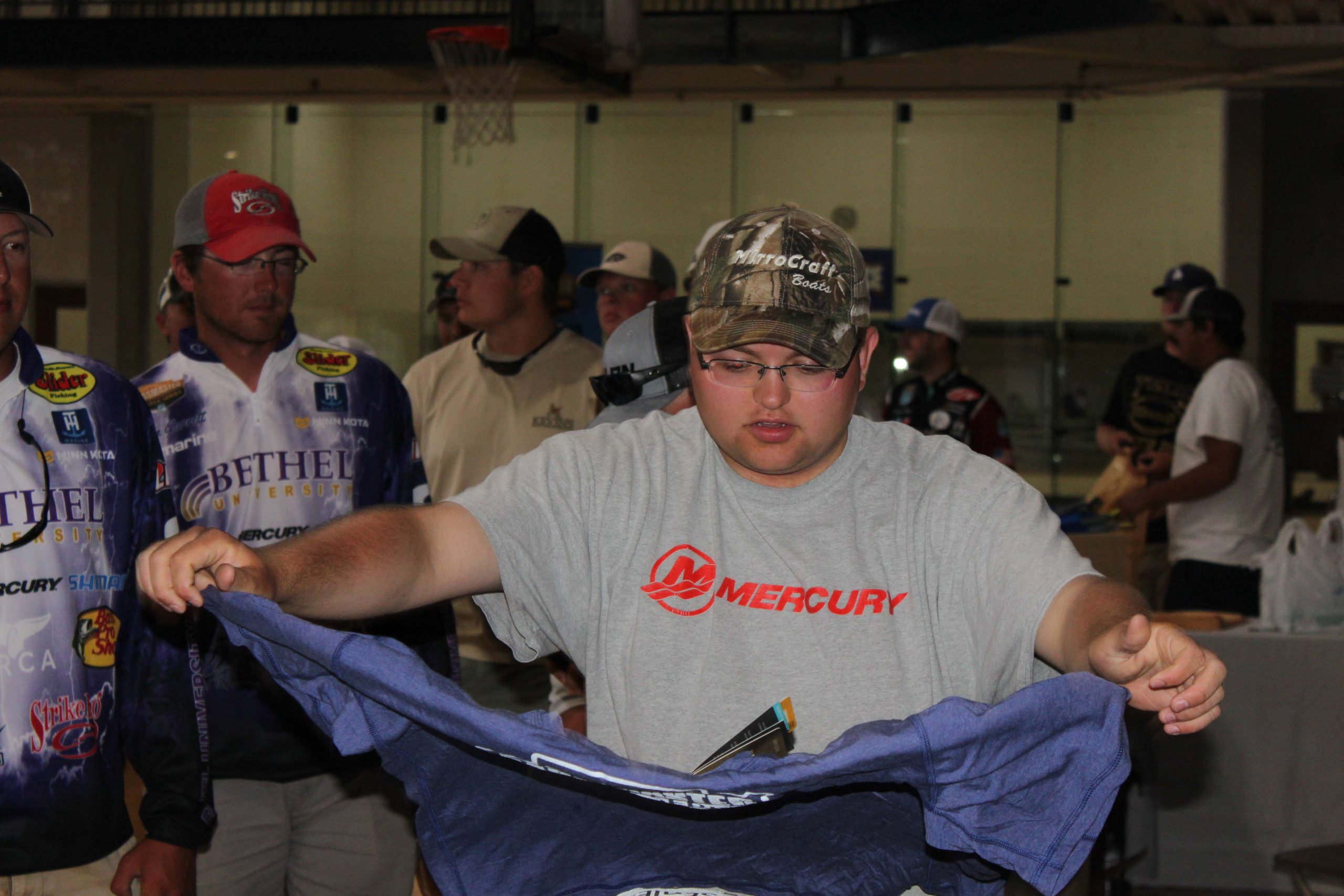  This angler sizes up a t-shirt to see if itâs the right fit.