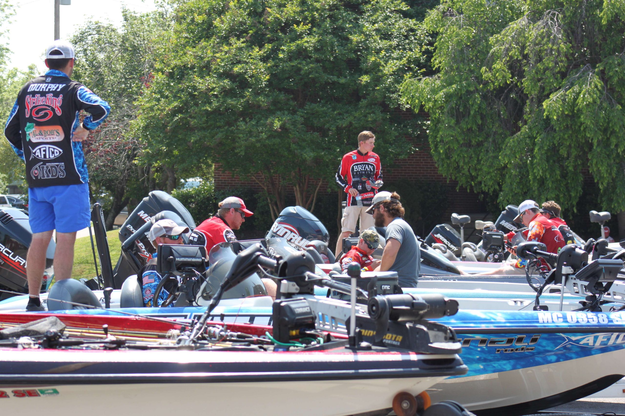 The anglers begin to line up in a parking lot near the weigh-in stage.