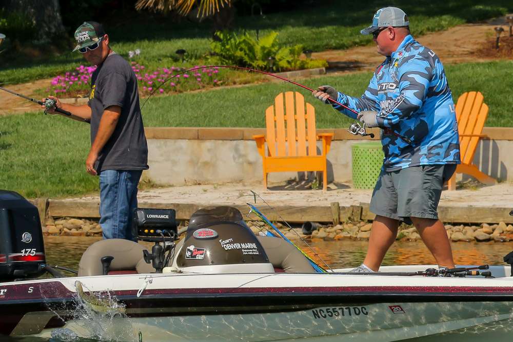 Lineberger swings a spotted bass in the boat.
