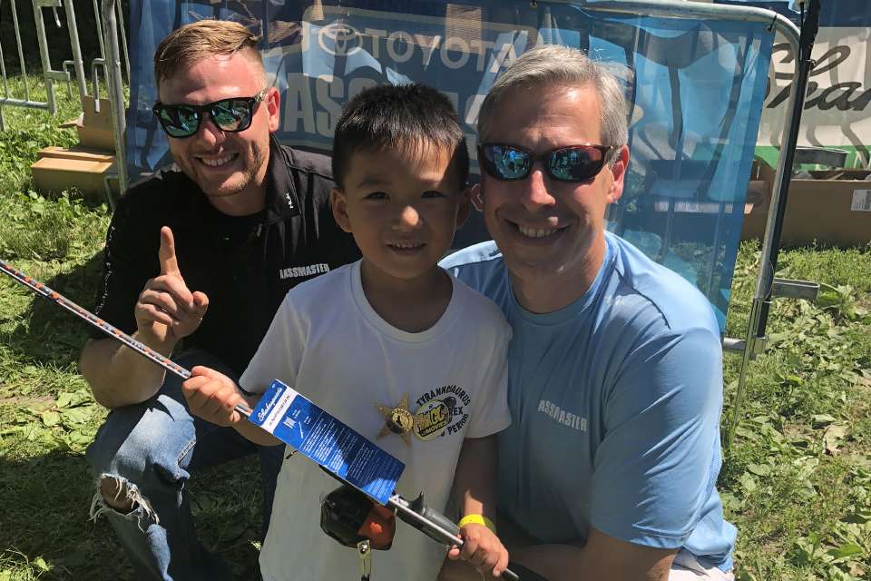 Volunteer Aaron Sarden and B.A.S.S. Event Director David Healy pose with one of the kids who took home a rod and reel.