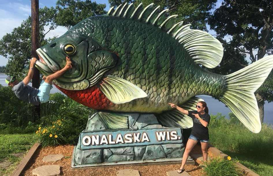 Before making the eight-hour trek, Wesley Strader and wife, Stephanie, have some fun Sunday at the huge bluegill statue at Onalaska Lake. Strader, who won an Elite and an Open this season, finished 12th on the Mississippi River.  