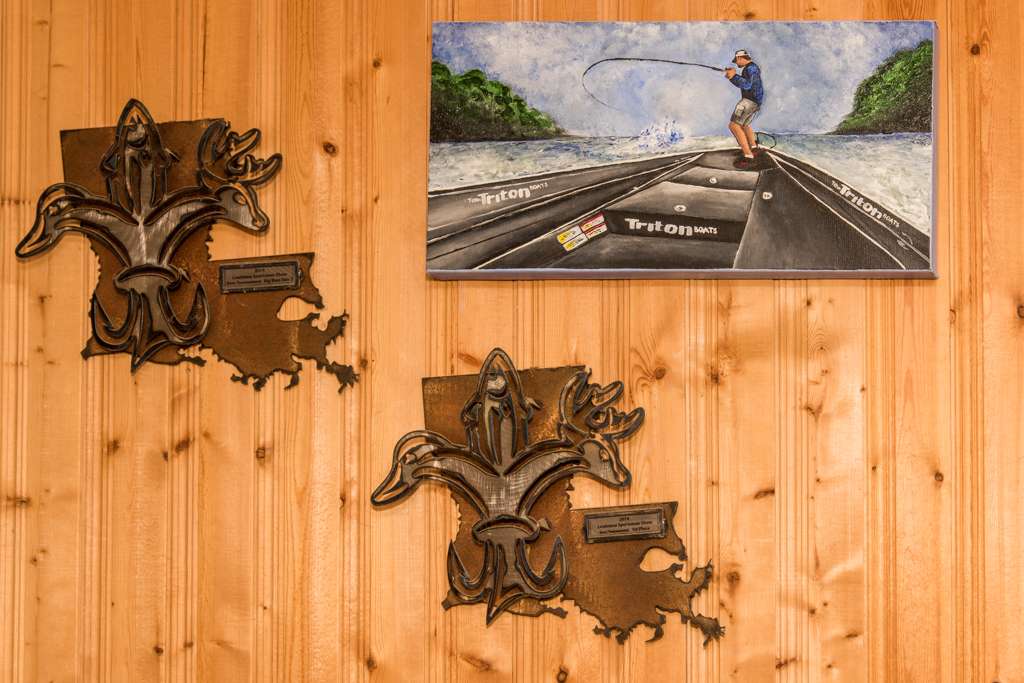 Two trophies from a local tournament frame the painting by family friend Kristin Stanberry. 