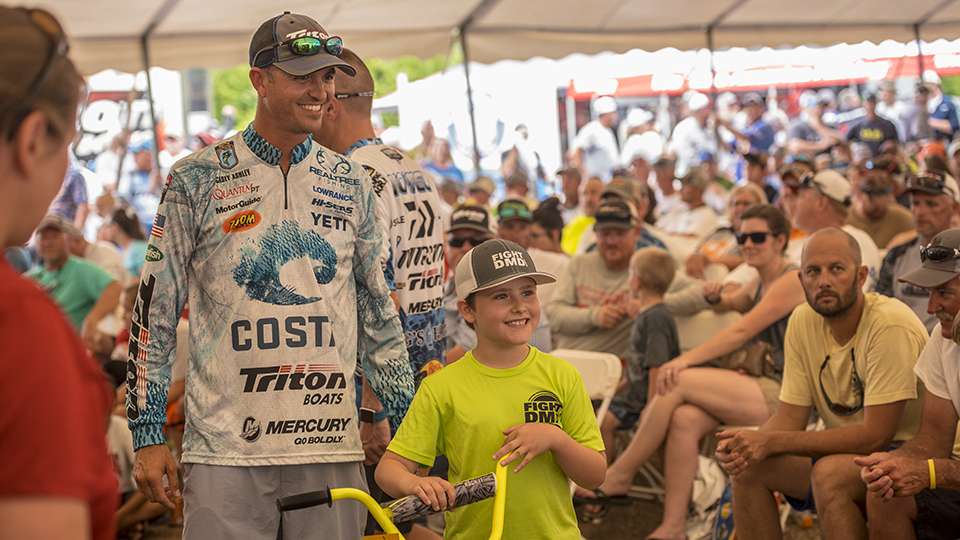 A young man wins a brand-new bike.  Door and raffle prizes were provided by: Lowrance, Strike King, Mercury & Motorguide, Duckett Rods, TH Marine, Power Pole, Dual Pro Charging Systems, Maui Jim sunglasses, Bass Pro Shops, Vicious Fishing, Star Brite, Motor Mate, Night Fishion, and Powertex Apparel.