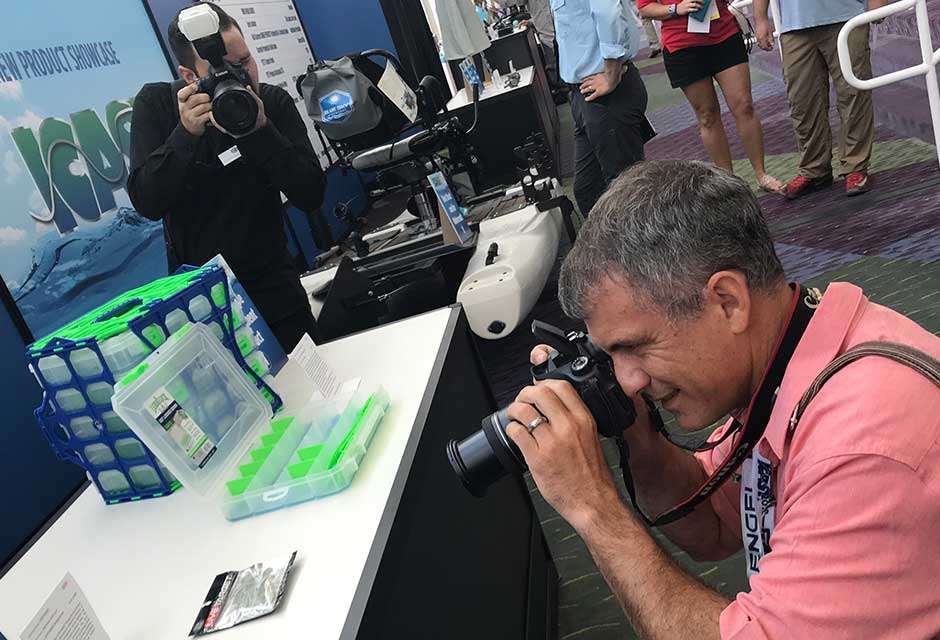 The 25 winners of the Best of Show awards were moved out to the concourse, and for the first time, voters looked them over to select the Overall Best of Show. Here, an ICAST official photographer takes shots of a photographer taking shots of some of the winning products.