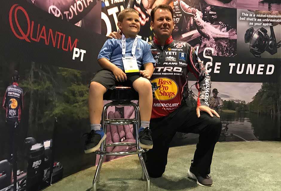 Kevin VanDam poses for a photo with Adian Jaggers at the Quantum booth. KVD recommends the lad start with the Accurist reel that comes in colors to suit your scheme.