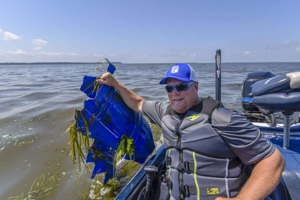 Greg Ledwell holds up a large piece of plastic that was found floating just below the waterâs surface in Chesapeake Bay.